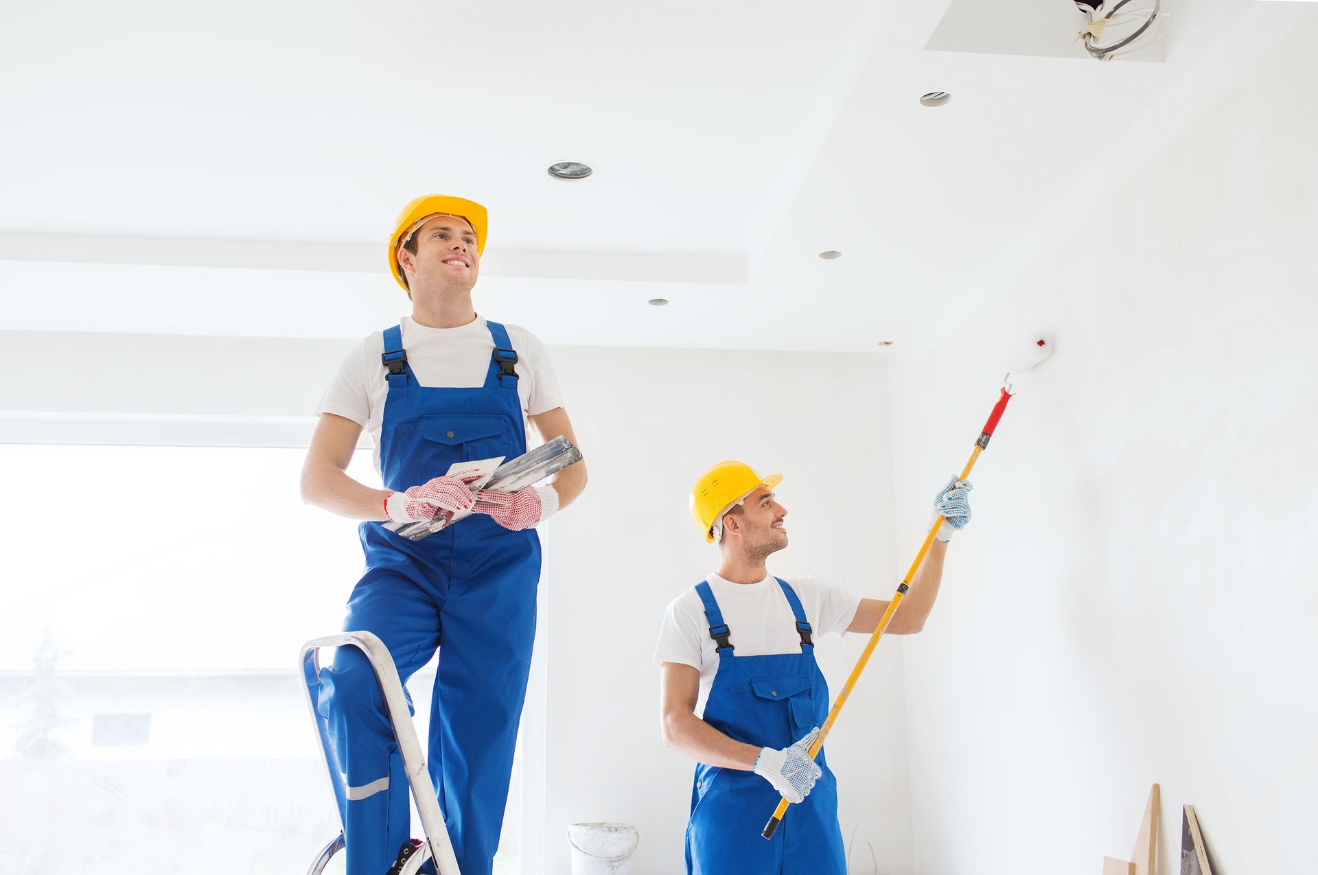group of builders with tools indoors