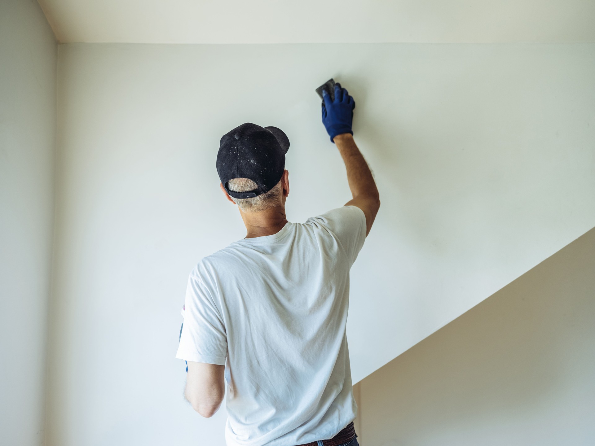 Senior man painting apartment interior